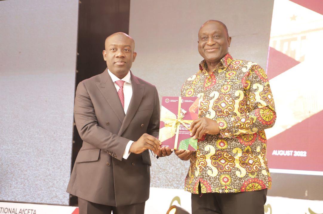 Kojo Oppong Nkrumah (left), Minister of Information and Alan Kyeremanten displaying a copy of the AfCFTA National policy document after the launch in Accra. Picture: Samuel Tei Adano.
